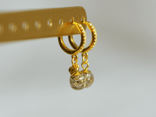 Close-up of Lusia earrings with the horse hair visible inside the resin bead