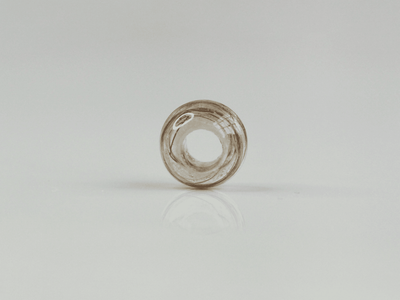 Thea bead — a handmade resin bead with hair wound inside it, shown without a chain